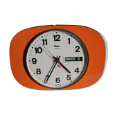 Vintage wall clock in orange formica