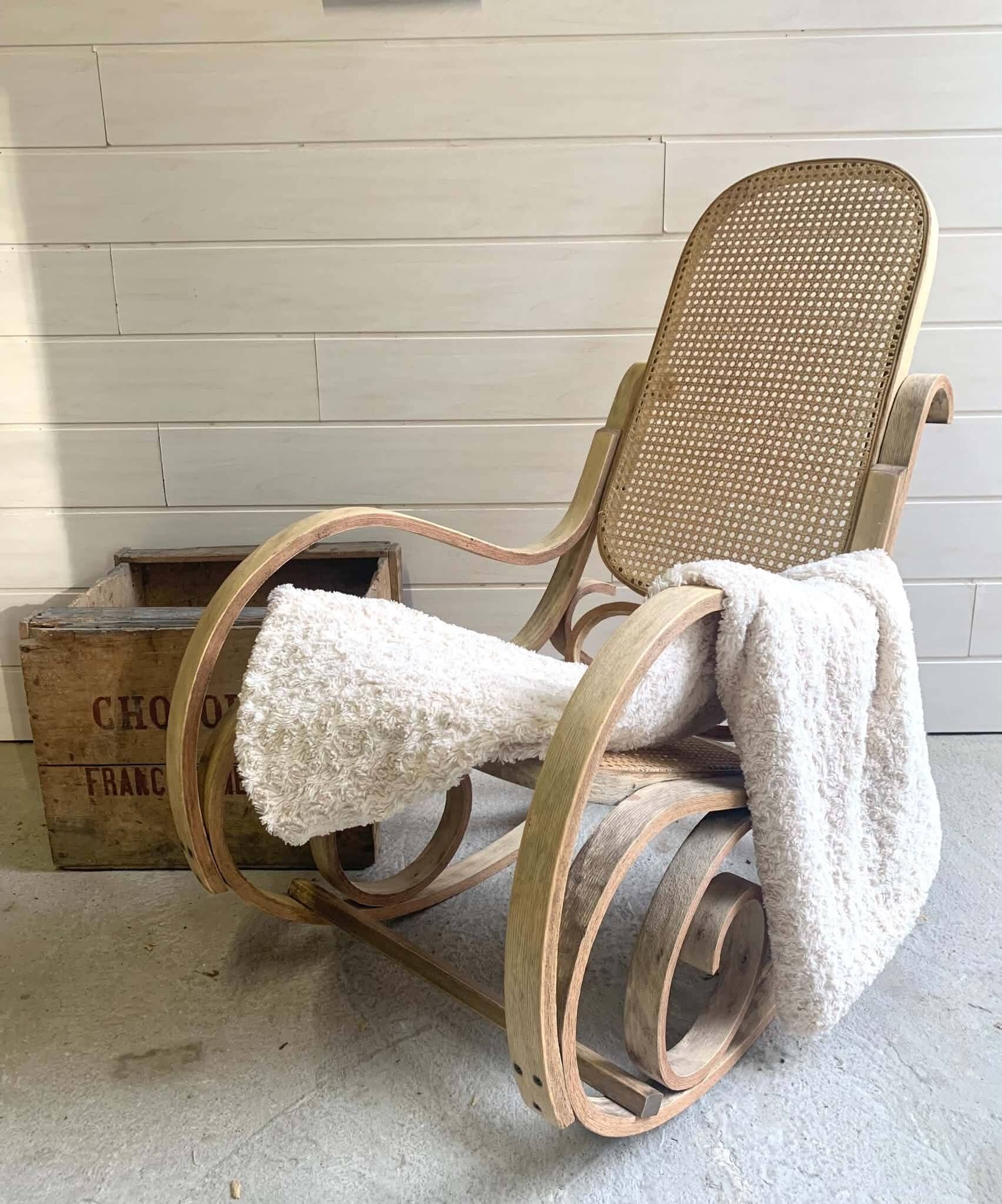 Rocking chair with a cane seat and backrest.