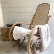 Rocking chair with a cane seat and backrest.