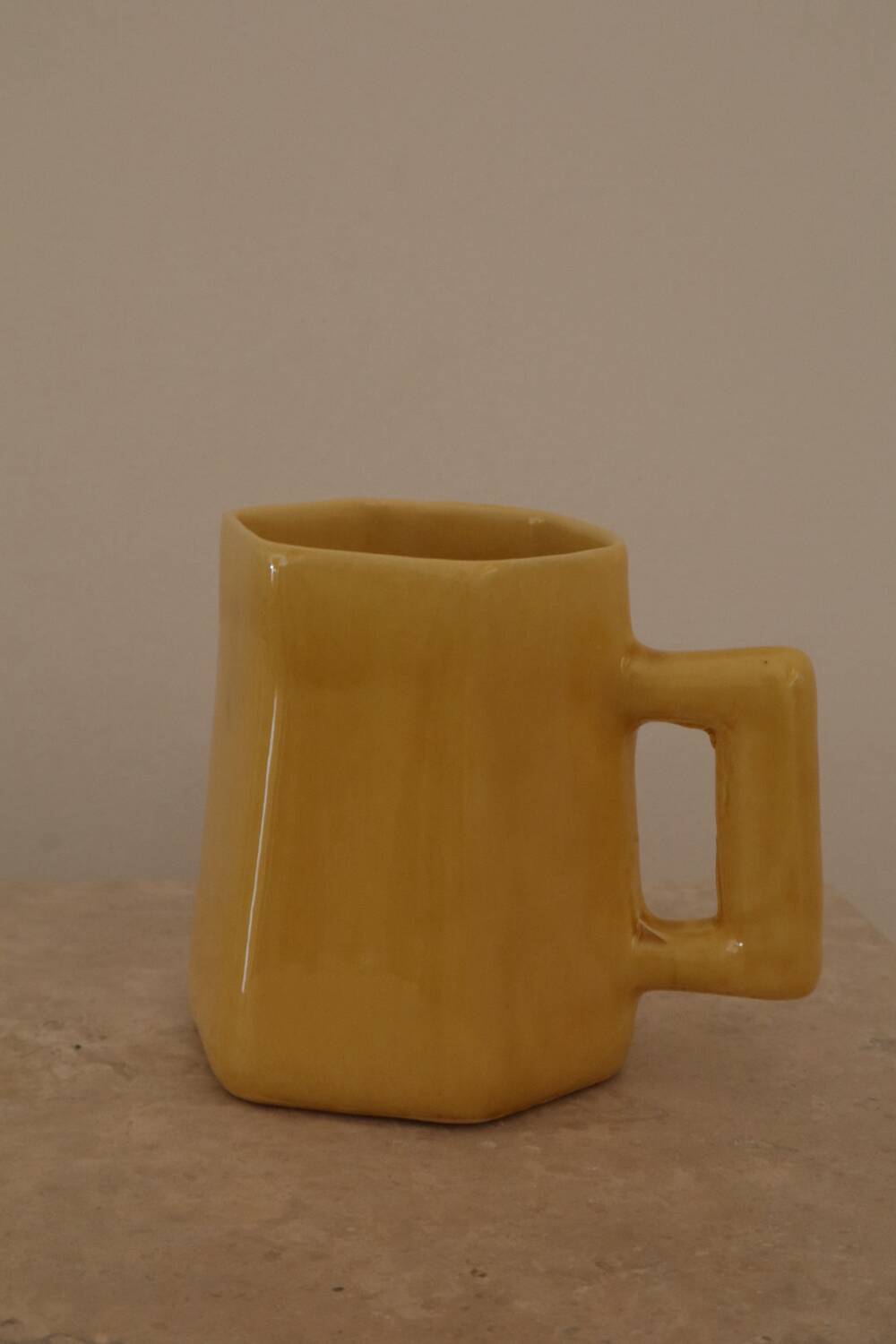 Set of two designer lemon yellow ceramic mugs