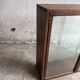Dark-stained wood and glass vintage display cabinet — early 20th-century wall-mounted showcase