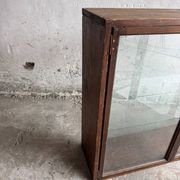 Dark-stained wood and glass vintage display cabinet — early 20th-century wall-mounted showcase