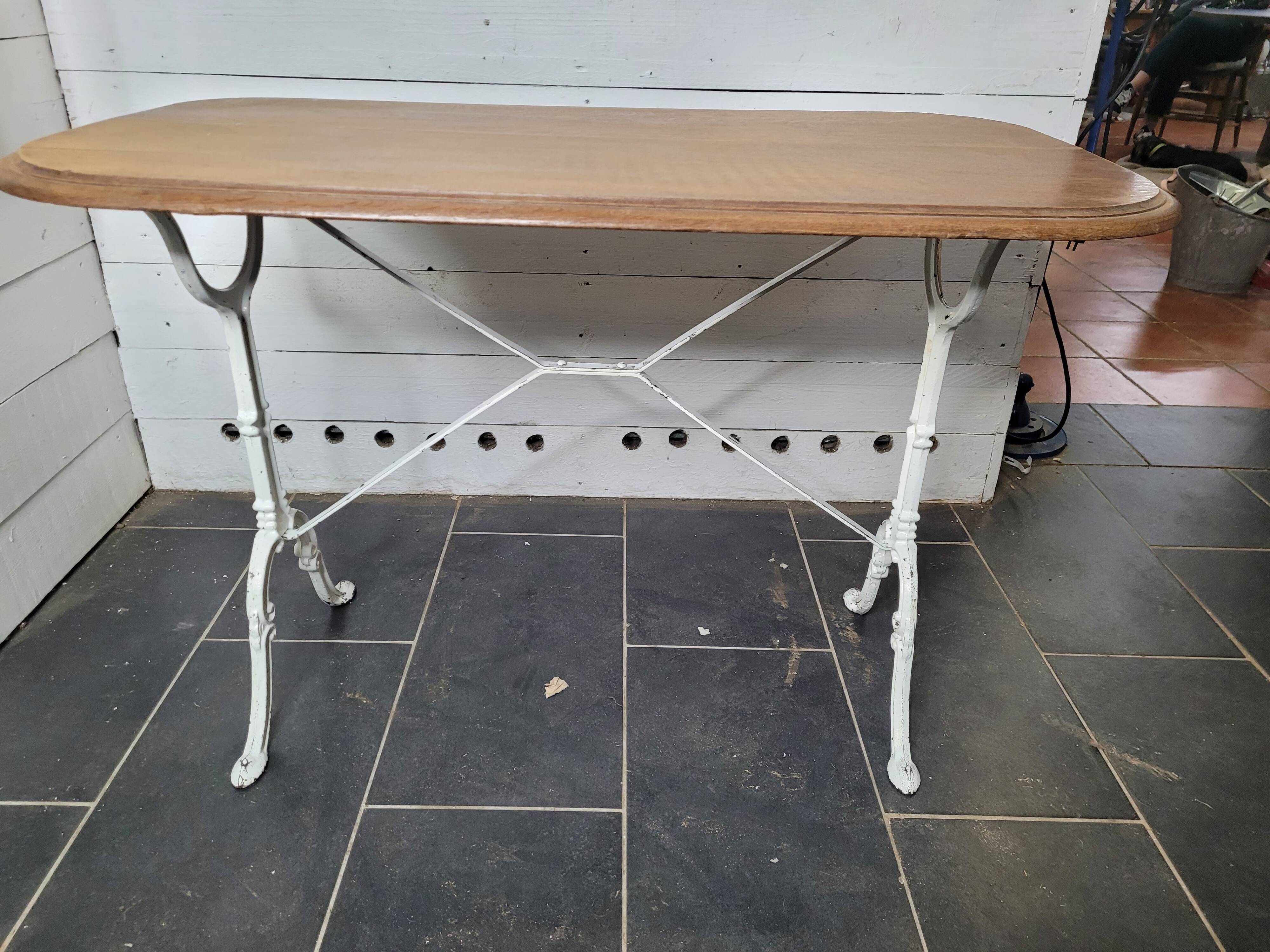 Bistro table with cast iron base and oak top