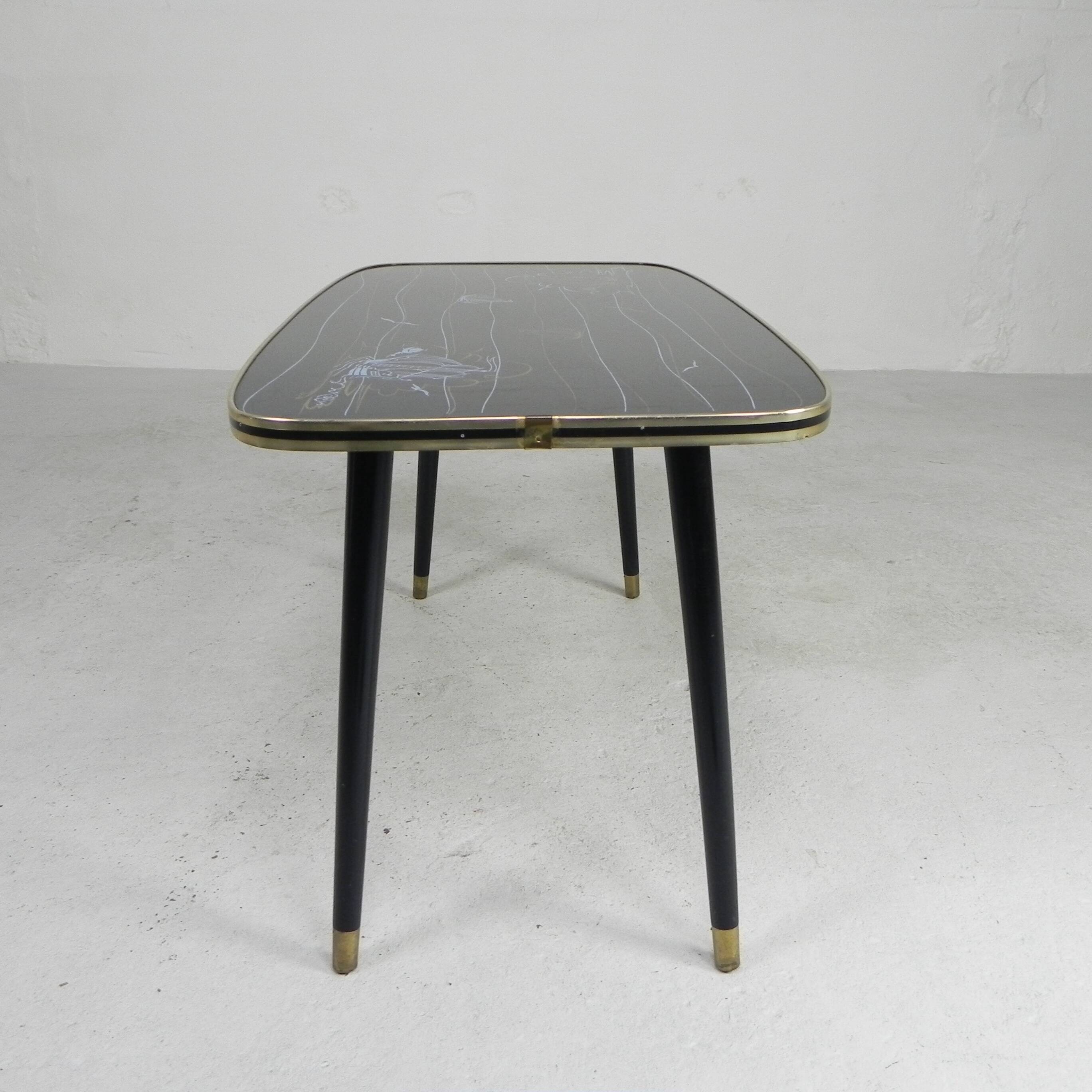 Vintage coffee table with glass top and angled legs