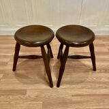 A pair of tripod stools from the period.