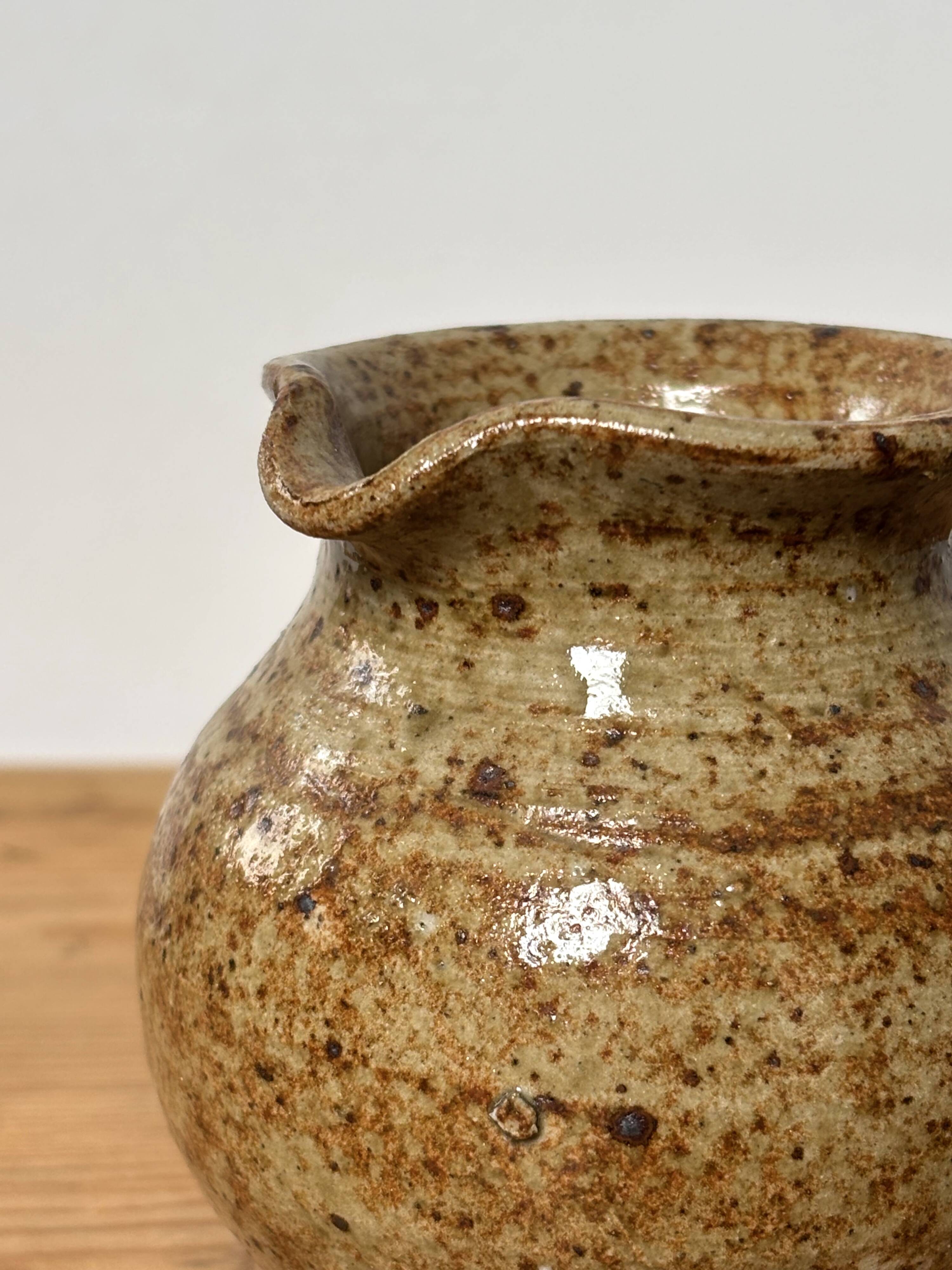 Small beige speckled stoneware pitcher
