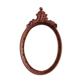 Oval frame with carved pediment
