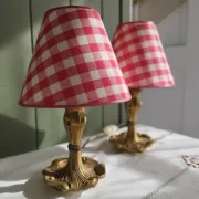 Pair of small lamps in gilded bronze by Petitot and red gingham lampshades.