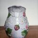 Barbotine pitcher with pastel flower decoration