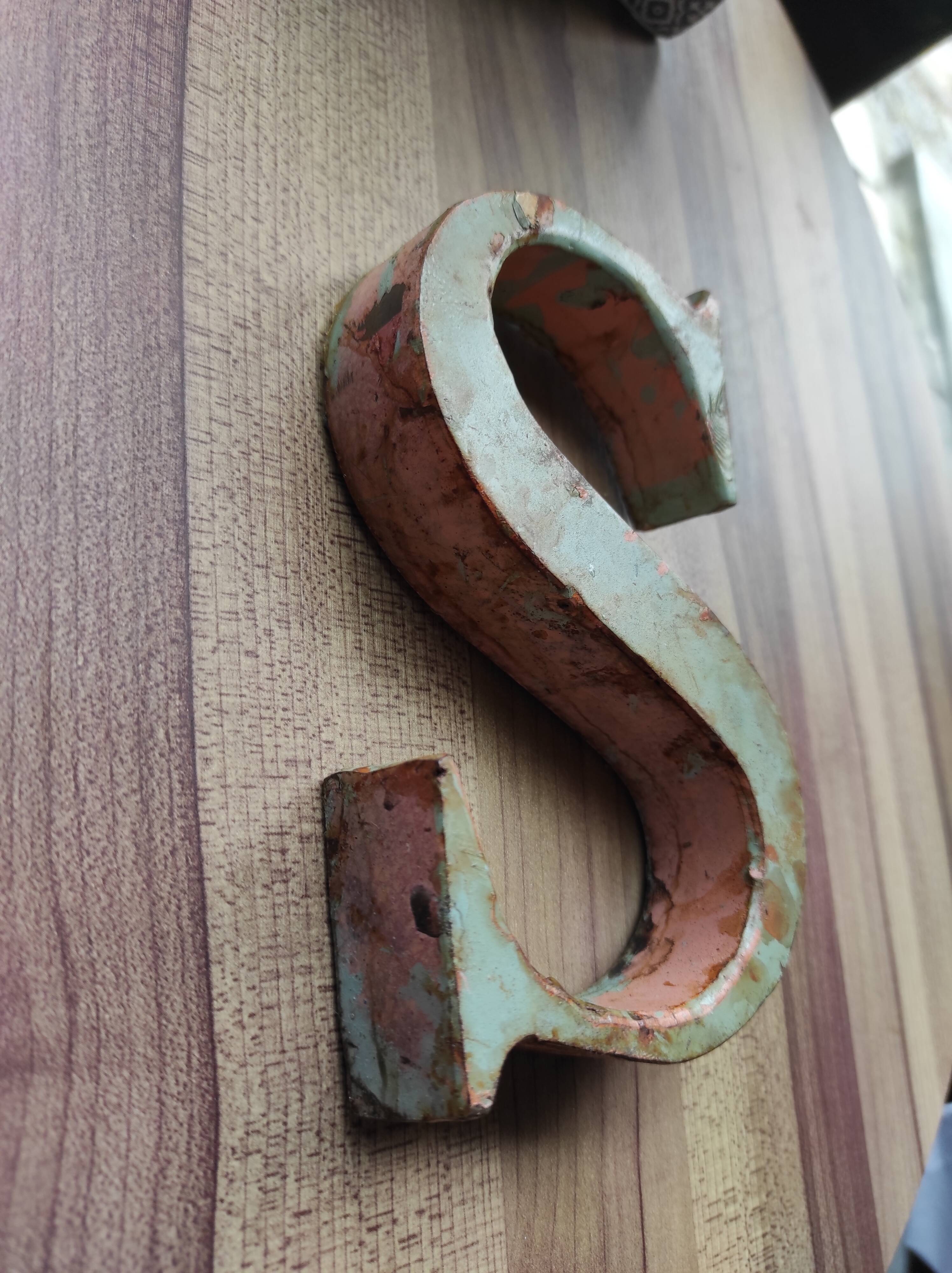 Old sign letter "S" in patinated metal
