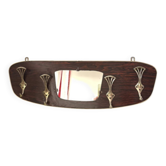 Wall-mounted coat rack in wood and brass from the 1960s.