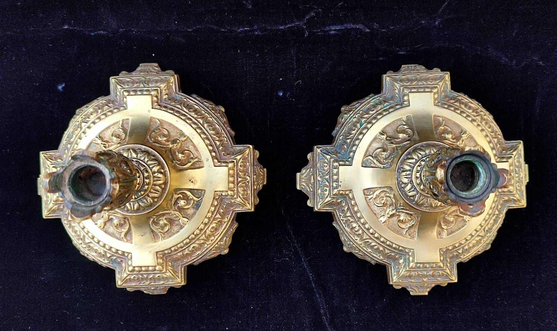 Pair of antique carved bronze candlesticks.