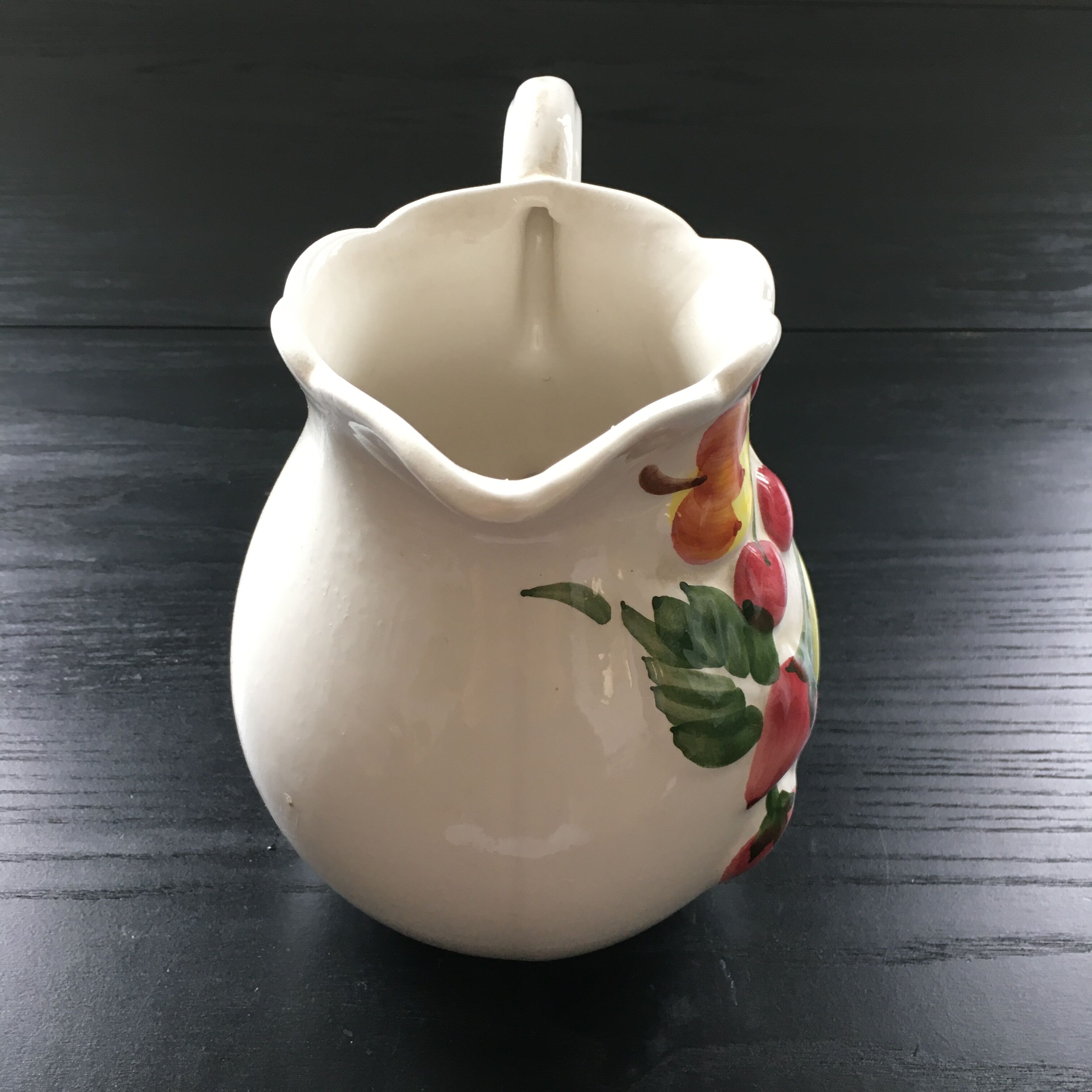 Fruit-decorated pitcher in slipware