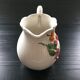 Fruit-decorated pitcher in slipware
