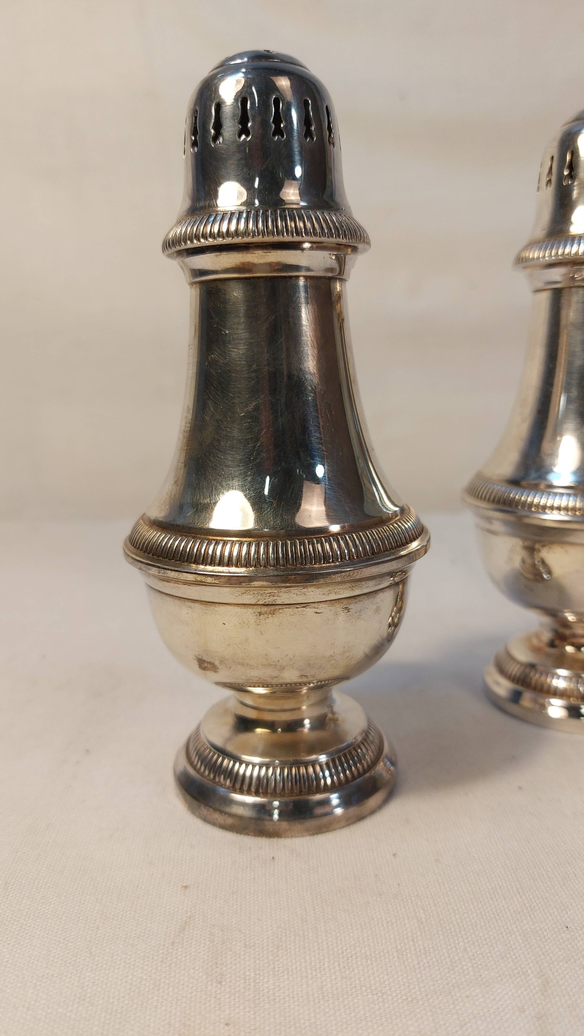 Set of two silver metal sprinklers