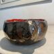Deep red glazed and metallic ceramic catchall.