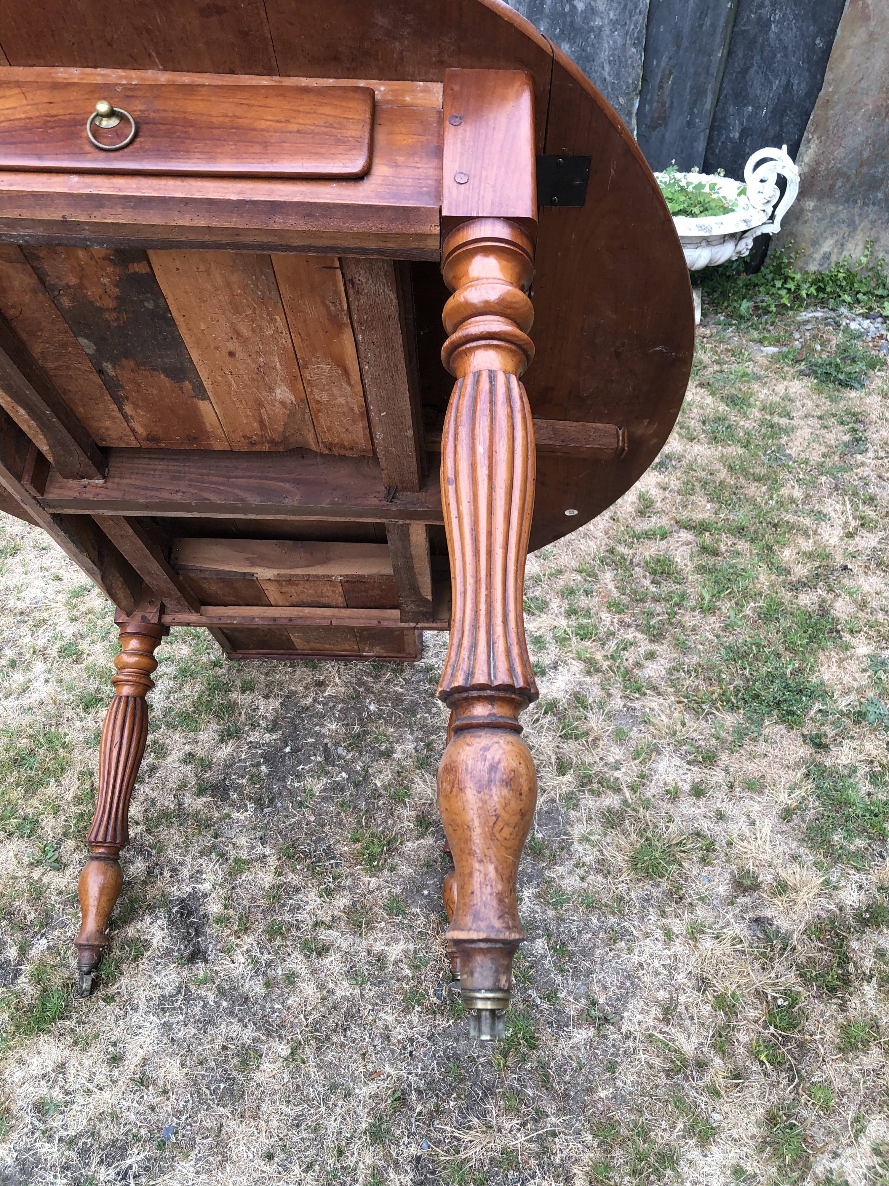 Louis Philippe oval drop-leaf table in solid cherry wood with 2 drawers.