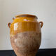 Old grease pot in glazed yellow terracotta, France nineteenth century
