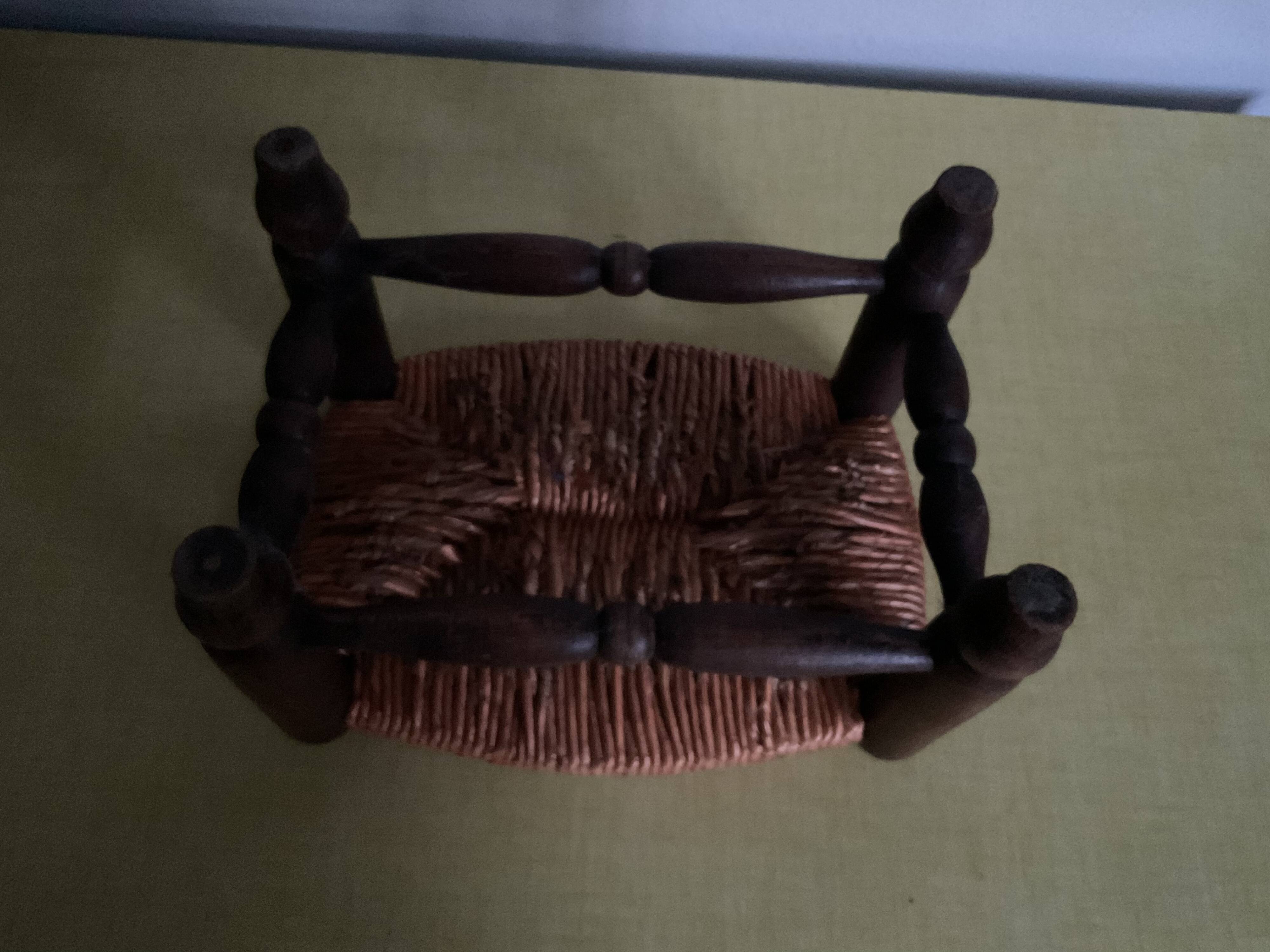 Turned wooden stool and straw