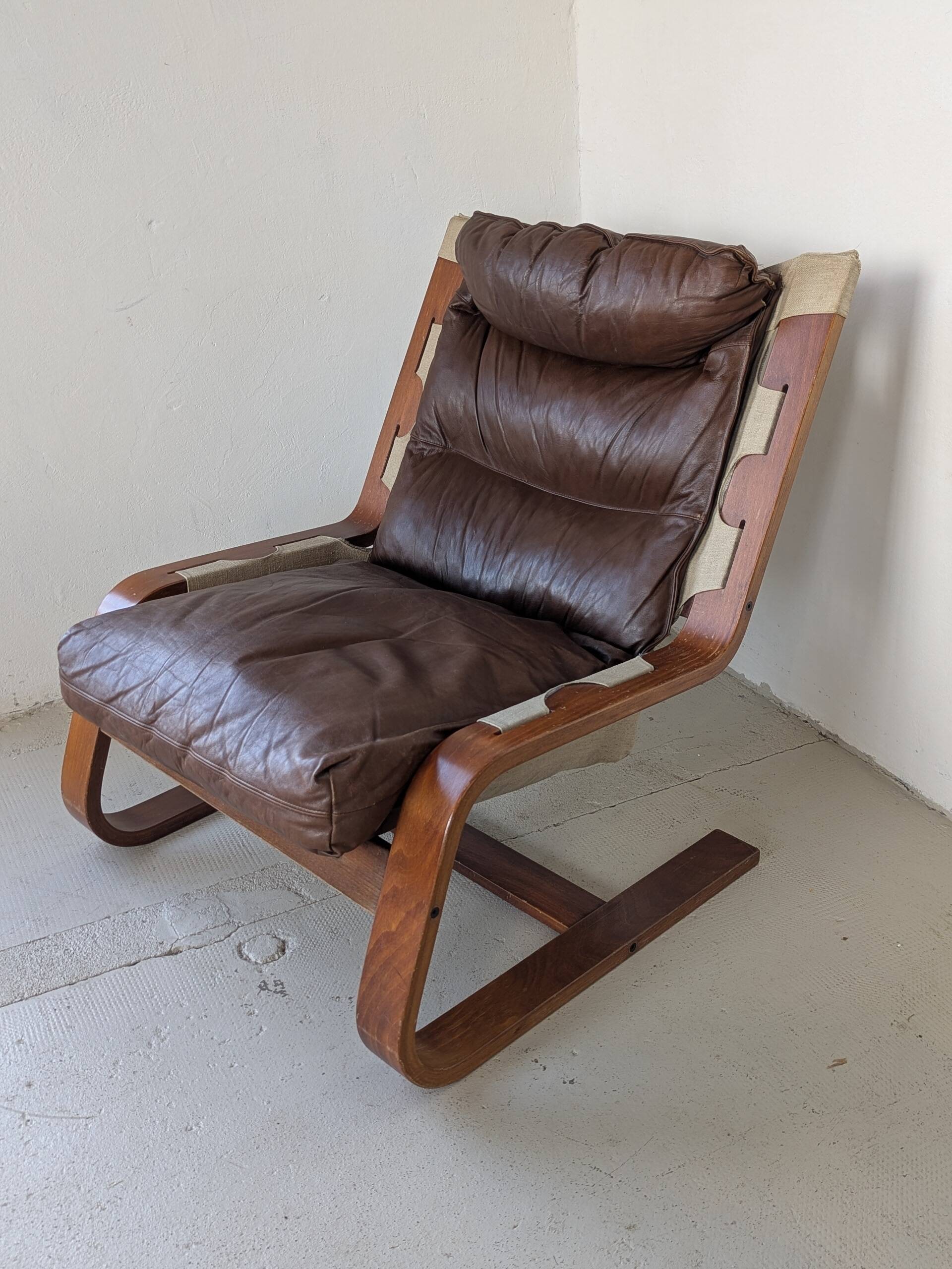 Leather and wood armchair, brutalist style.