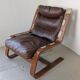 Leather and wood armchair, brutalist style.