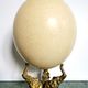 Ancient ostrich egg naturalized on bronze base representing 3 elephants