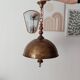 Rustic old wooden and brass suspension.