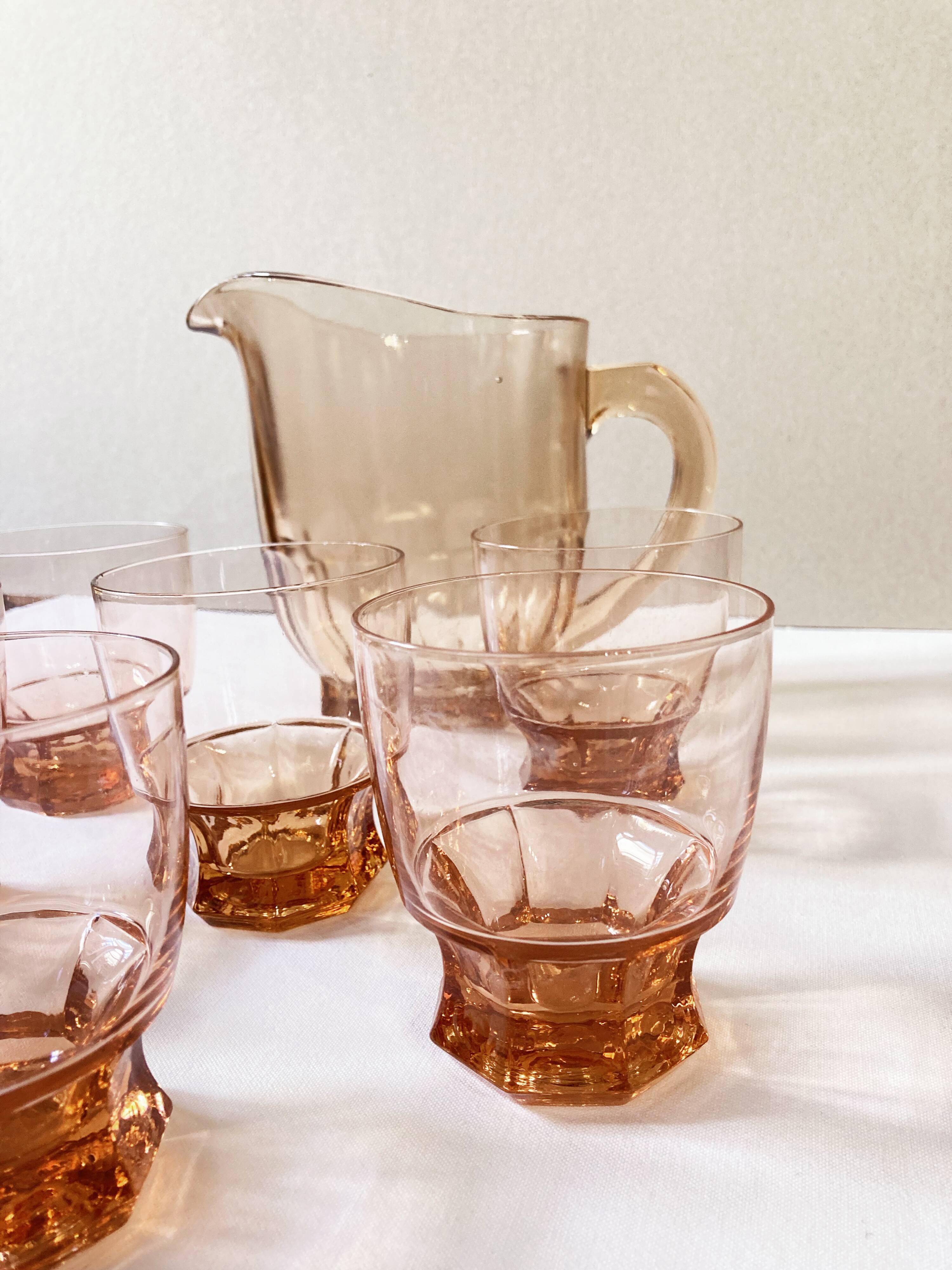 Pitcher and 6 water glasses in pink glass