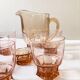 Pitcher and 6 water glasses in pink glass