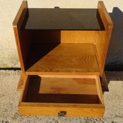 Vintage oak bedside table with tapered legs.