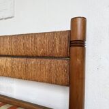 Brutalist style bed with chain and straw