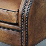 Large and comfortable sheepskin leather wingback chair with black piping