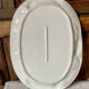 Very large serving dish with hares and vegetables.