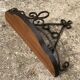 Old wrought iron console with a fleur-de-lis design.