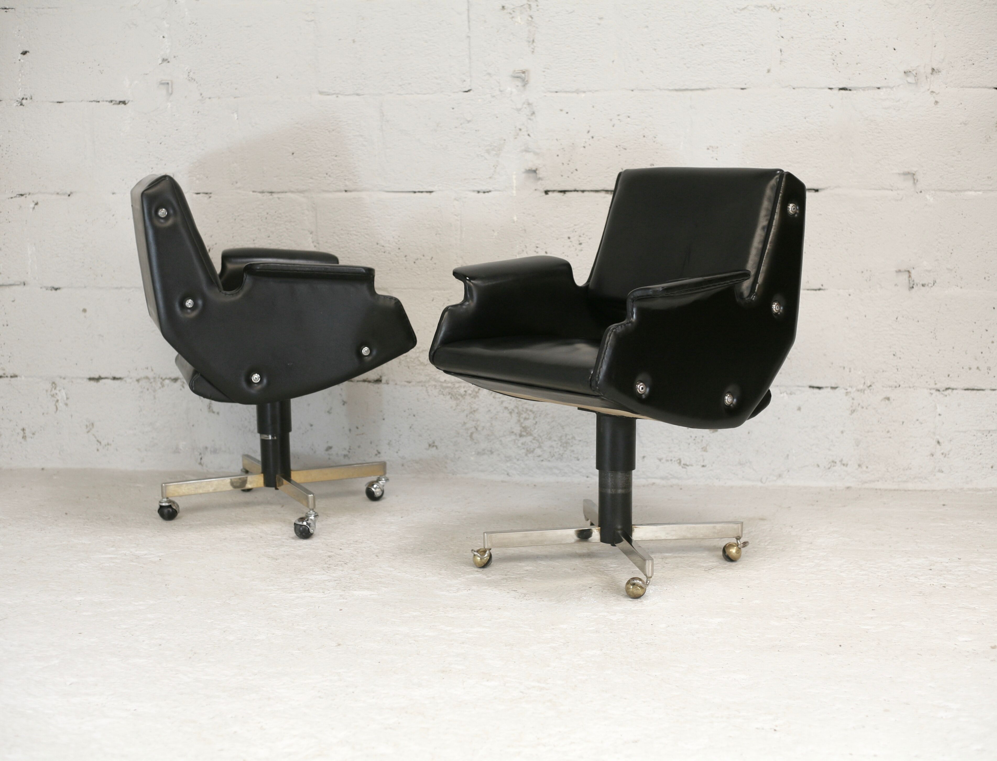 Pair of swivel armchairs, imitation leather and steel, Italy, circa 1960.