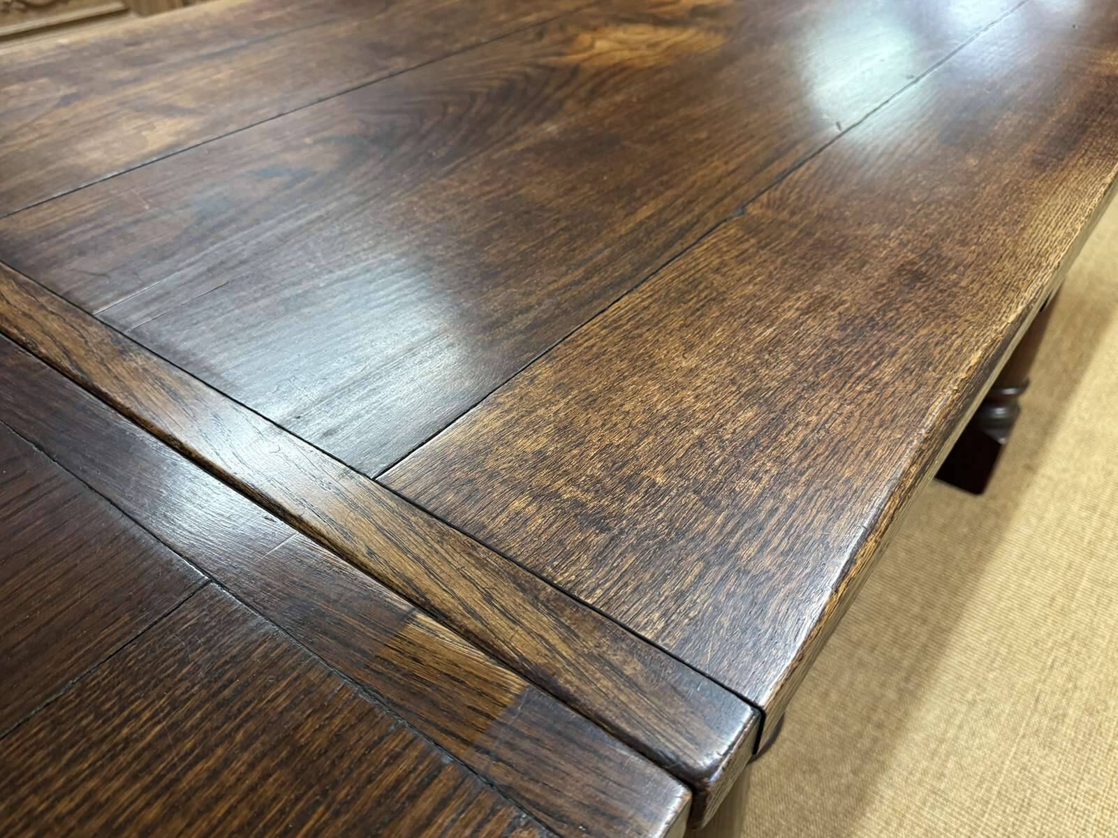 English monastery table with extensions from the late 19th century in elm and oak.