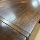 English monastery table with extensions from the late 19th century in elm and oak.