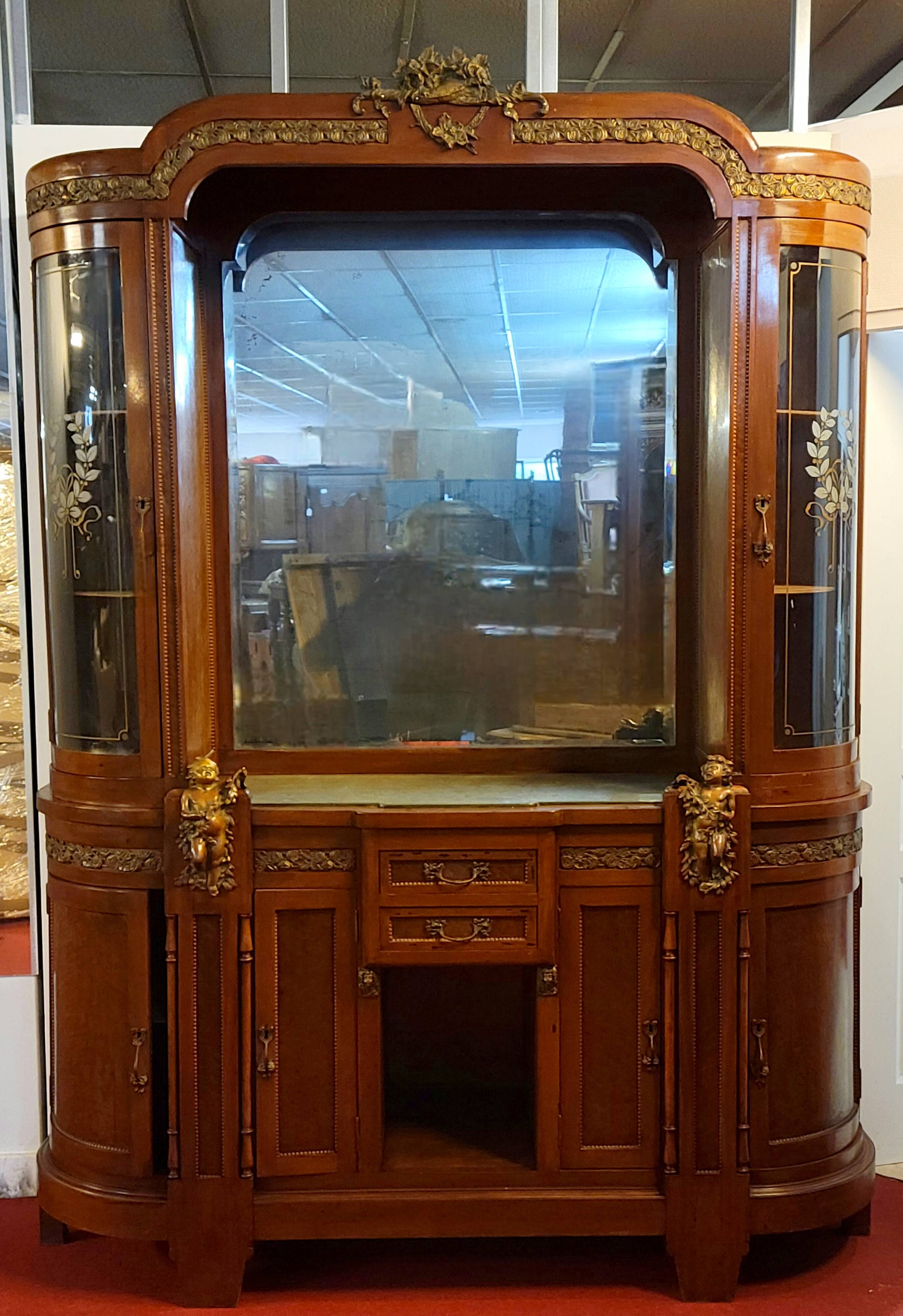 Empire style half-moon shaped mahogany bookcase with putti
