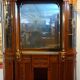 Empire style half-moon shaped mahogany bookcase with putti