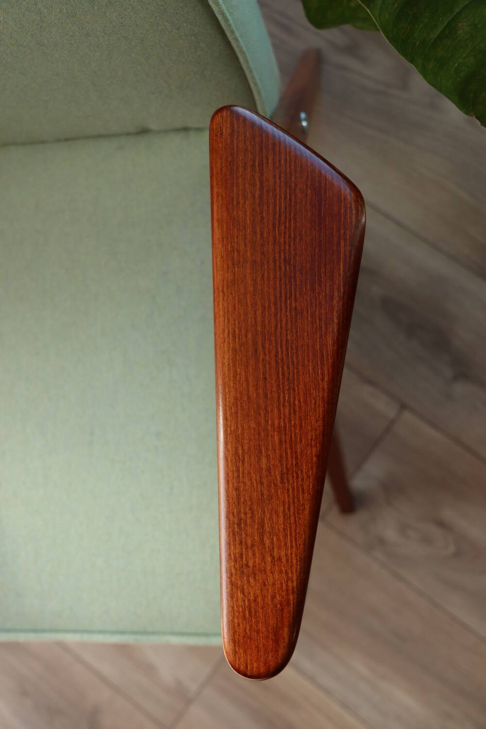 Vintage armchair in mint green wool, mid-century modern design.