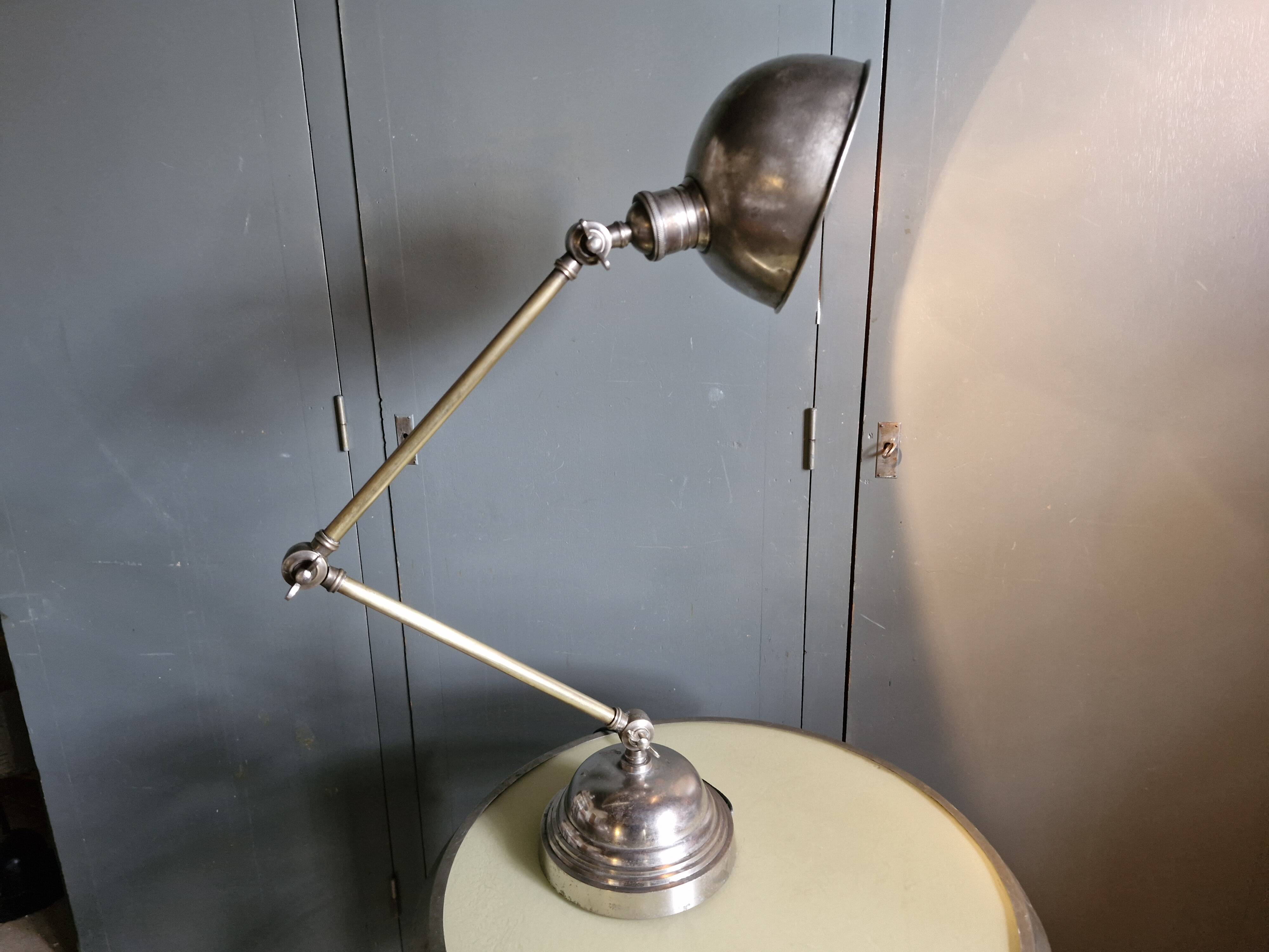 Old adjustable industrial lamp in bronze with 2 arms.