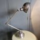 Old adjustable industrial lamp in bronze with 2 arms.