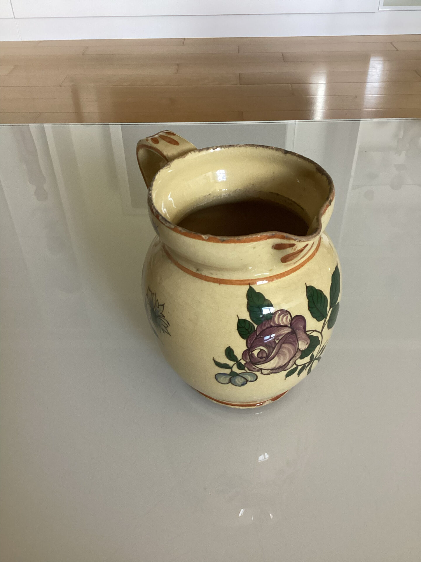 Old ceramic jug with floral decoration