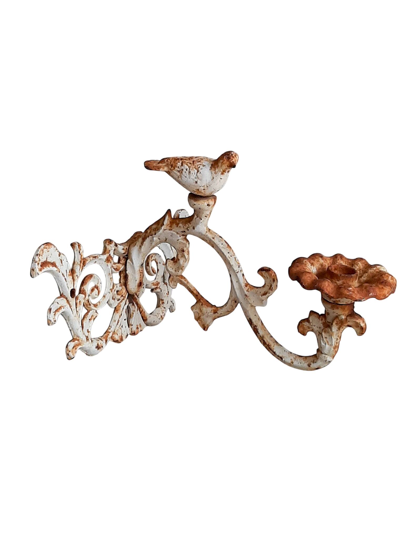 Wall lamp in antique cast iron with bird and scroll decorations.