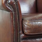 Sheepskin armchair correctly finished with decorative nails and in good condition