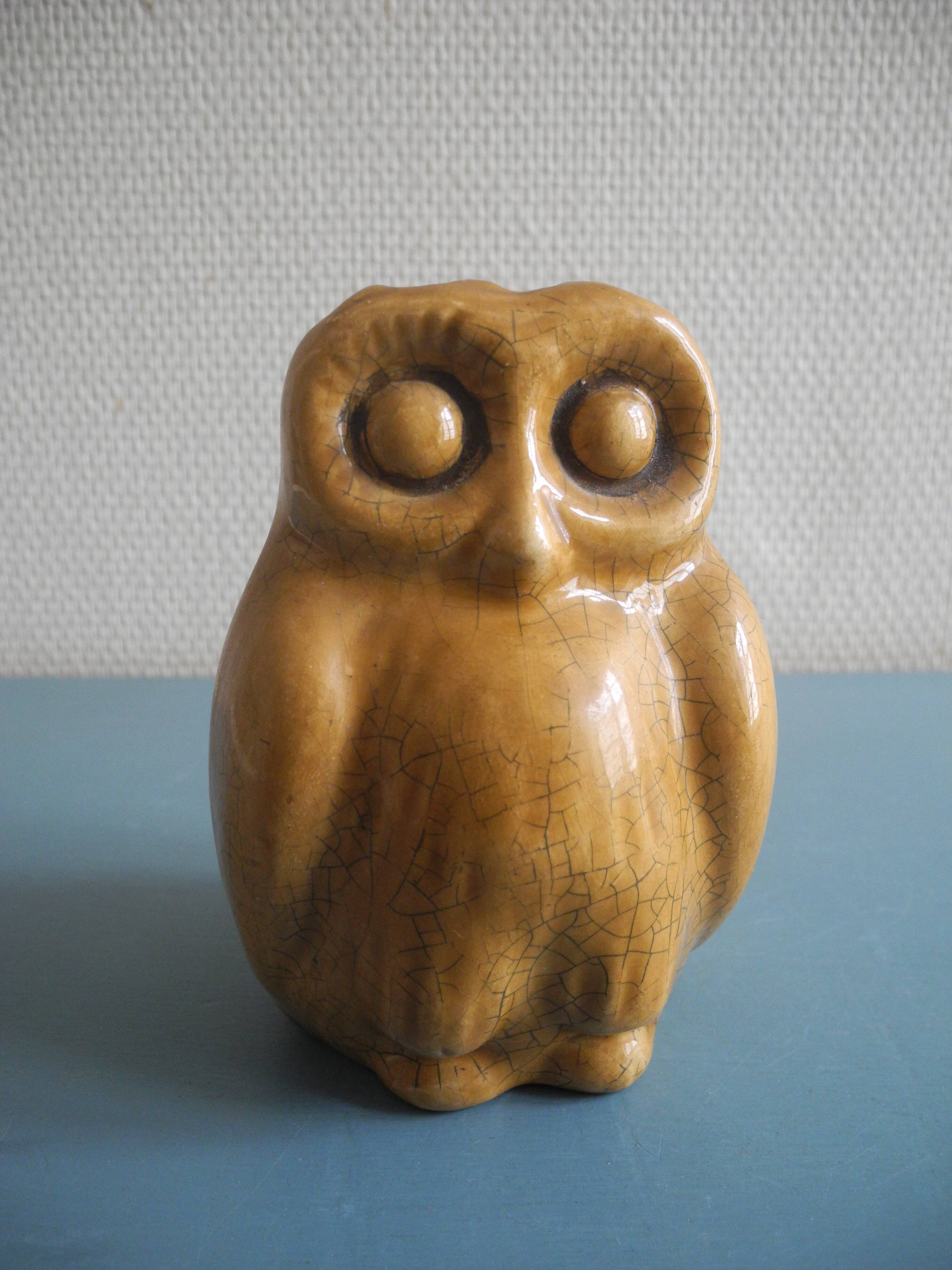 vintage earthenware vase with an old flower pick and an owl decoration