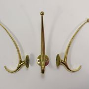 Two curved wall coat racks in brass by Franz Hagenauer, Vienna, mid-20th century, 1950s.
