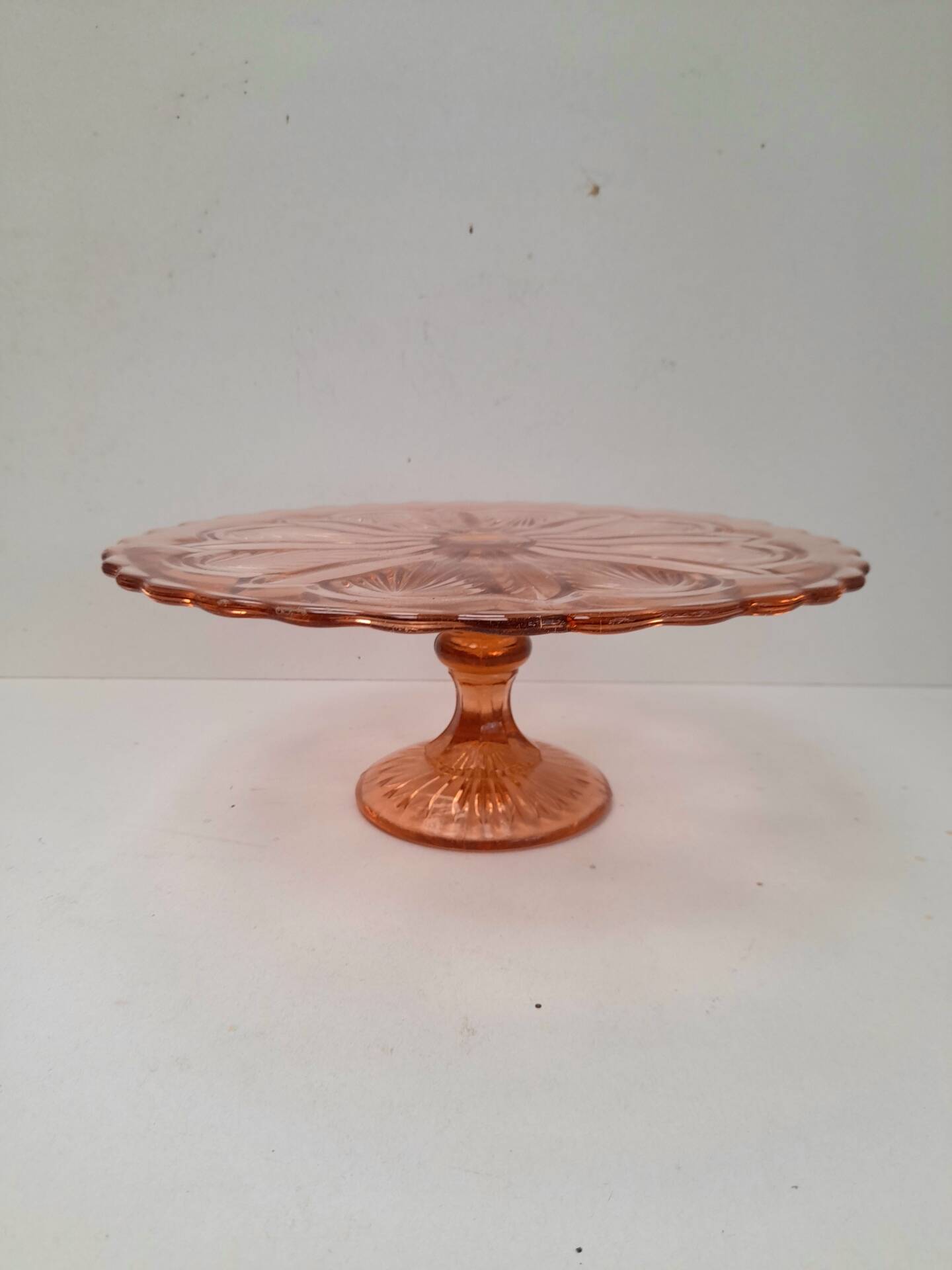 Pink pressed glass cake stand