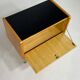 Pair of bedside tables in wood, brass and black glass top