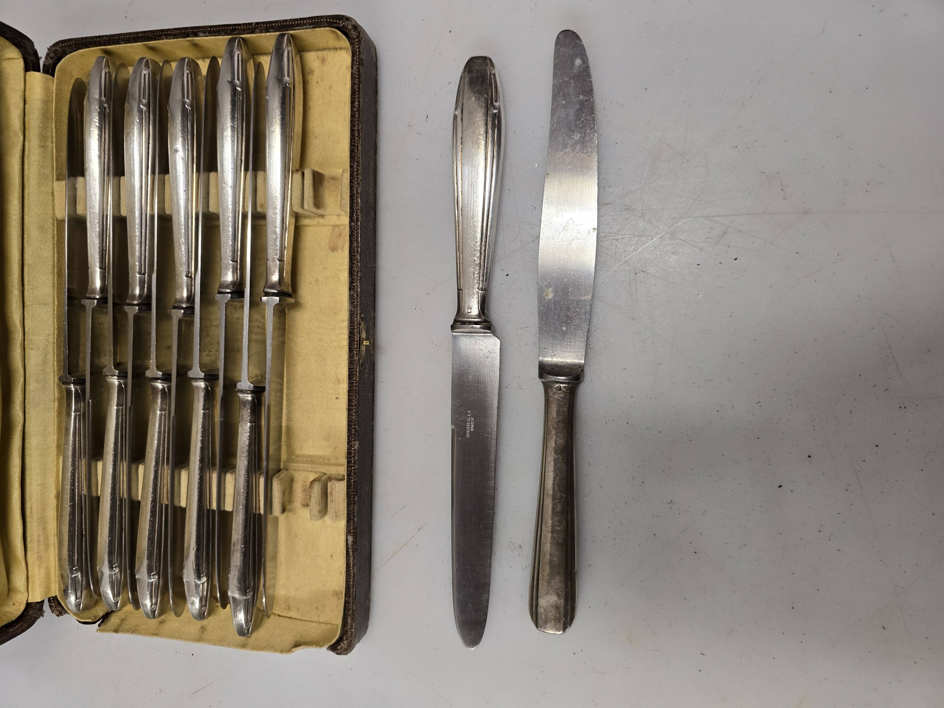 12 silver-plated knives from the mid-20th century